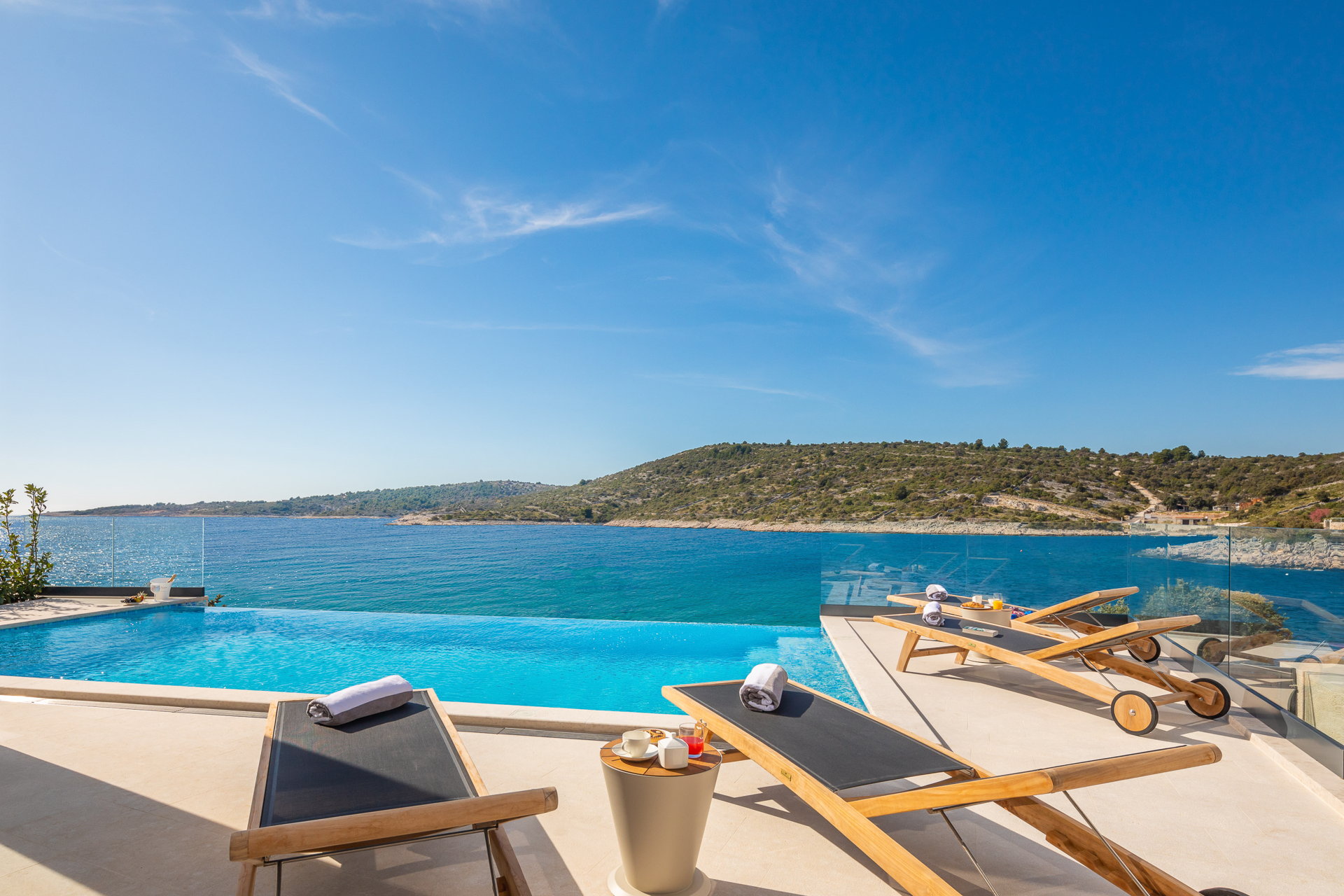 Luxury villa with an infinity pool, sun loungers, and stunning sea views in Primošten, Croatia