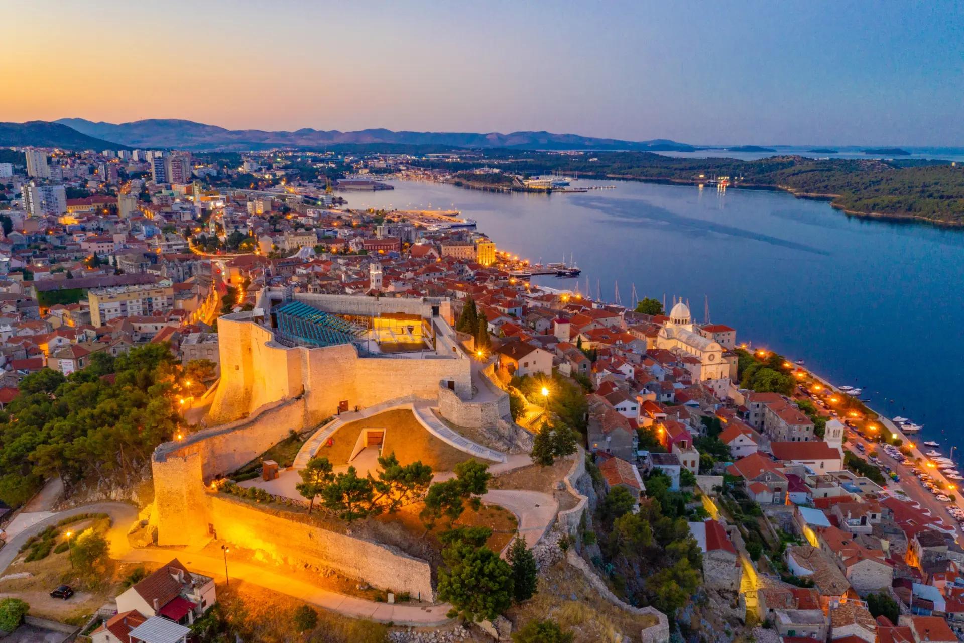 Aerial view of Sibenik, Croatia, at dusk, with St. Michael's Fortress and and tranquil waters of the Adriatic Sea
