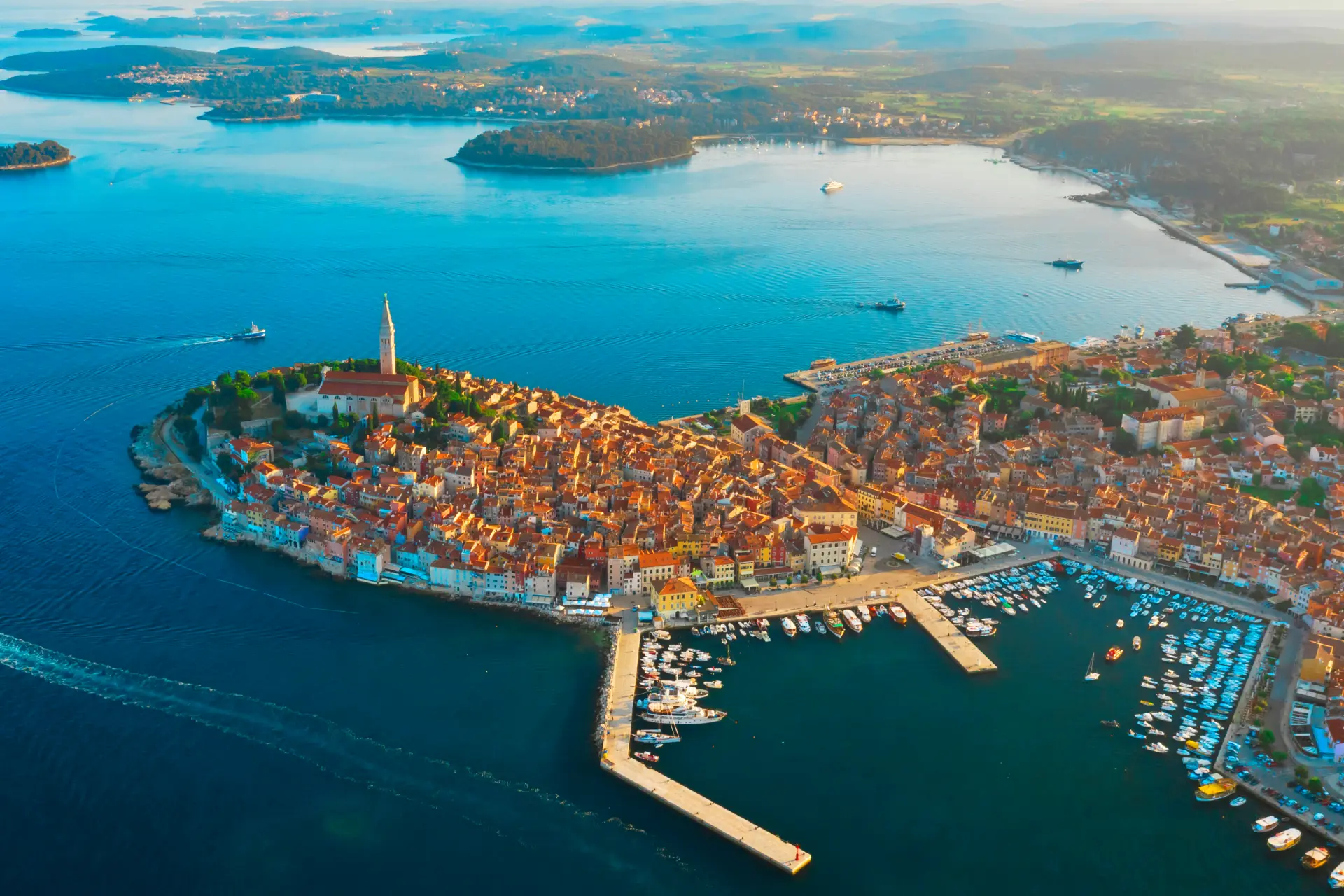 Aerial view of Rovinj, Croatia, a charming coastal town with a historic center, marina, and vibrant waterfront